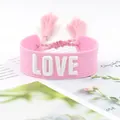 Close-up of pink woven tassel bracelet with white 3D embroidered LOVE lettering detail - 27#