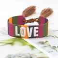 Colorful woven friendship bracelet with white LOVE embroidery and boho tassels - Color 33