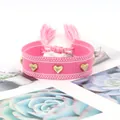 Pink woven bohemian bracelet featuring three golden heart studs and tassels - Gold Heart Rivets / Pink (H-G-007)