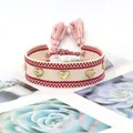 Handmade woven bracelet in beige and red with golden heart charms and tassels - Gold Heart Rivets / Beige and Red Interwoven (H-G-011)