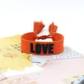 Handwoven orange friendship bracelet with black LOVE embroidery and stylish tassels - Style 44 Black Bird Print