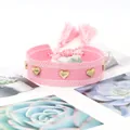 Pink woven wristband with golden heart rivets and matching tassels in a sweet style - Gold Heart Rivets / Pink and White Mixed (H-G-018)
