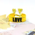 Yellow braided tassel bracelet featuring black LOVE embroidery for friendship - Style 45 Red Floral