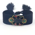 Vintage geweven armband met gouden details, edelstenen en zwarte kwastjes - Zwart