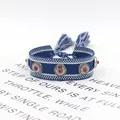 Detail of bohemian woven bracelet with silver studs, red beads and tassel fringes - 12# (Blue and White)