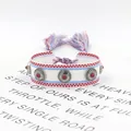 Detail of woven bohemian friendship bracelet with metal studs and tassels on card - 18# (Red White and Blue)
