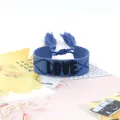 Adjustable blue woven friendship bracelet featuring 3D embroidered LOVE text and tassels - Style 52 Beige Leaf