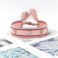 Bracelet tissé rose avec rayures rouges, rivets en cœur et nœuds à glands - Rayé Rose Rouge
