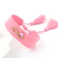 Pink woven infinity bracelet with gold-tone rhinestones and tassel drawstrings - Pink