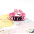 Adjustable pink woven wristband with black LOVE embroidery and decorative tassels - Style 64 Navy Multi-color Floral