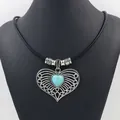 Vintage heart pendant necklace with turquoise stone on black rope cord displayed on bust - Hollow Heart Style