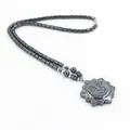 Hematiet kralenketting met een gestileerde zonnegezicht hanger in donkergrijs - Zonstijl