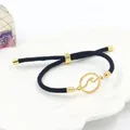 Bracciale nero intrecciato regolabile con ciondolo a onda in acciaio dorato in piatto - Stile Onda Oro