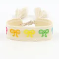 Ethnic embroidered friendship bracelet with colorful bow patterns and tassels - Bow