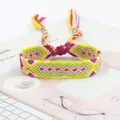 Close-up of handmade woven friendship bracelet with colorful geometric patterns and tassels - Yellow Pink Green White Purple Geometric Style (A#(6))