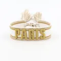 Embroidered white and gold PARIS lettered woven cotton friendship bracelet with tassels - Bronze PARIS Embroidery Tassel / Bronze PARIS