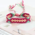 Detail of handmade woven rainbow friendship bracelet with colorful geometric patterns - Red Purple Yellow Green Geometric Style (A#(8))