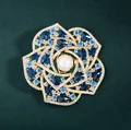 Elegant camellia flower brooch with white pearl and blue crystals on gold base - Blue Camellia