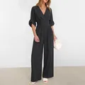 Detail of elegant black V-neck wide-leg jumpsuit with puff sleeves and layered waist - 3XL / Black