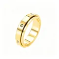Detail of a golden spinning ring with three sparkling crystals and high-polish finish - US 5 / Zirconia Inlaid / Gold