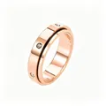 Close-up of rose gold rotating ring featuring black line detail and inlaid crystal stones - US 5 / Zirconia Inlaid / Rose Gold