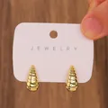 Vintage golden C-shaped textured conch earrings set on white display card - Gold Spiral Conch Stud Earrings / 14K Gold (N-196)