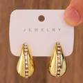 Chunky gold teardrop hoop earrings with crystal inlay on a jewelry display card - Gold Rhinestone Inlaid Teardrop Earrings / Light KC Gold (5513)