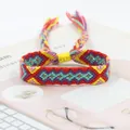 Detailed macro view of handmade bohemian friendship bracelet with colorful fringe tassels - Red Yellow Purple Cyan Pink Geometric Style (A#(10))