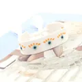White bohemian woven bracelet with embroidered evil eye motif and tassel drawstrings - Evil Eye Style / White