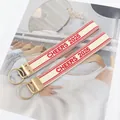 Set of two off-white woven wristlet keychains with red Cheers 2025 embroidery and gold ring - Cream White with Red Edge Style / Cream Red CHEERS 2025