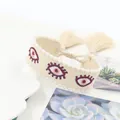 Bohemian woven cotton bracelet with evil eye embroidery and pearl bead trim with tassels - Off White