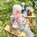 Detail of pink floral pet dress with lace edges and a large organza bow on green grass - Midsummer Floral Style Pink