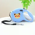 Close-up of blue retractable dog leash with cute bear pattern on white textured towel - Bear Head Style / Light Blue