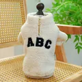 Dettaglio del caldo cappotto in sherpa per animali con ricamo ABC e zip dorata sul retro - XS / Bianco Sporco