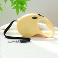 Cream yellow retractable dog leash with PETCIRCLE logo on a soft white blanket - Basic Style / Yellow