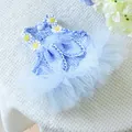 Close-up of Easter pet dress with blue gingham, daisy decor and white lace trim detail - Blue Plaid Rabbit Ear Tulle Skirt