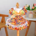 Detail of floral pet dress with orange background, white lace trim and large mesh bow - Orange Blossom Floral Dress