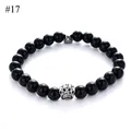 Detailed macro view of 8mm black stone bead bracelet with a silver hollow paw print charm - Black Obsidian Style(#17)