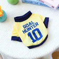 Detail of yellow dog soccer vest with Goal Hunter 10 print on white knitted rug - XS / Yellow