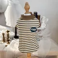 Close-up of vintage striped pet sweater with retro woven label and brown ribbed collar - Coffee Stripes