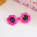 Vibrant rose pink flower shaped pet sunglasses with black round lenses on white surface - One Size / Red Flower Shaped Pet Sunglasses