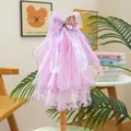 Close-up of a purple multi-layer mesh pet veil with a bow and shell detail - Purple Iridescent Shell Texture Style
