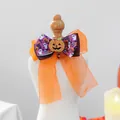 Macro detail of Halloween pet bow with orange pumpkin charm and small bell accessory - Sparkle Pumpkin Style