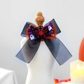 Close-up of Halloween pet bow with red glitter spider and pumpkin-themed ribbons - Spider Style