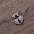 Vista macro di due ciondoli a cuore ghiacciati con catene a corda d'argento su legno scuro - Pendaglio Coppia Argento con Catena a Corda