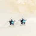 925 sterling silver star stud earrings with dark blue stone and cubic zirconia halo - White Gold