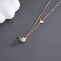Rose gold necklace featuring a heart charm and a mother-of-pearl whale tail pendant - Necklace-O Chain / Rose Gold