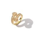 Detailed macro view of gold-plated copper ring featuring crisscross bands and baguette zircons - US 7 / Gold