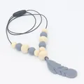 Close-up of silicone feather pendant and natural wooden beads for baby teething necklace - Dark Gray