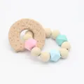 Detail of baby beech wood teething ring and pastel silicone beads for infant motor development - Donut